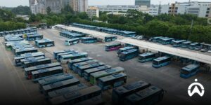 A row of company buses in the parking area is monitored using Cartrack GPS tracker as the right solution for public transportation.