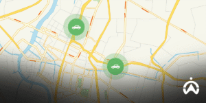 Peta navigasi pada aplikasi mobile Cartrack GPS tracker yang menunjukkan rute perjalanan dan dua ikon lokasi kendaraan berwarna hijau.