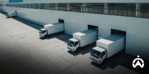 A queue of logistics trucks at a shipping warehouse managed by Cartrack Indonesia's Fleet Management System for fleet efficiency.