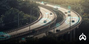 Pemandangan udara jalan raya dengan pelacakan kendaraan pintar menggunakan GPS software untuk bisnis yang ditandai indikator digital biru.
