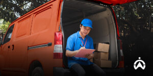 Couriers are recording logistics schedules in the van to improve delivery efficiency with the fleet management system.