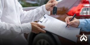 Car rental contract signing process with GPS tracker for rental business security.