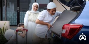 Families load luggage into the car for a comfortable trip in a private vehicle equipped with Cartrack.