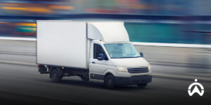 A delivery truck speeds along the highway, illustrating the benefits of task management tools to improve the work efficiency of a company's dispatch controller.