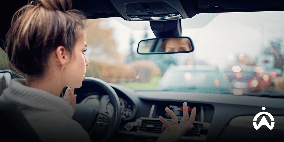 Female driver caught in traffic jam, describing the causes and how fleets avoid congestion.