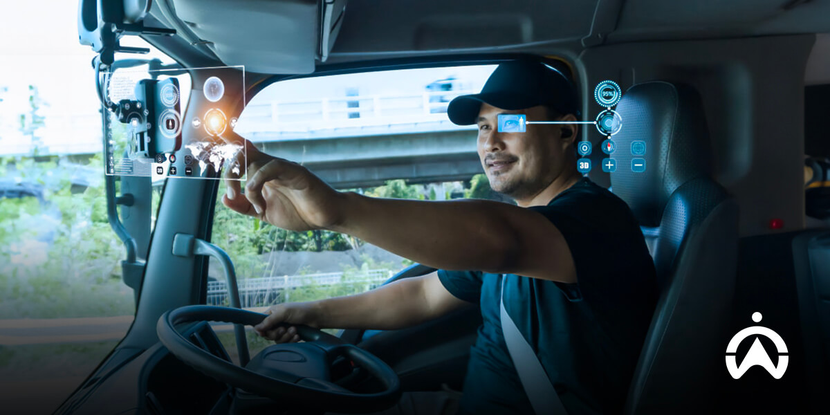 Pengemudi menggunakan layar antarmuka digital dalam mobil, menekankan pentingnya pelatihan mengemudi lanjutan untuk teknologi modern.