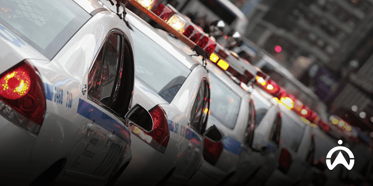 A line of police cars utilizing a fleet management system for operational effectiveness on city streets.