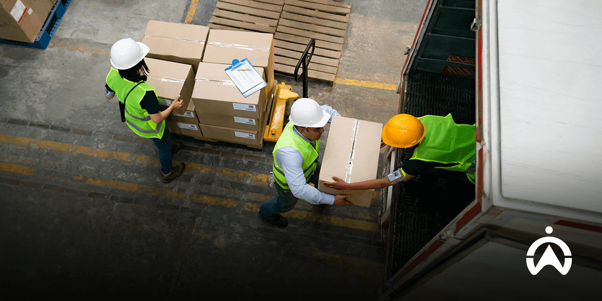 Pekerja gudang memuat kardus ke truk untuk mencegah risiko muatan overload pada angkutan barang.