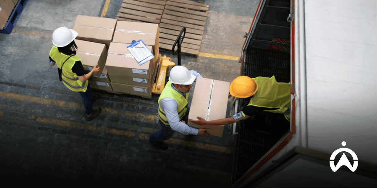 Warehouse workers load boxes into a cargo truck equipped with cargo door sensors to minimize theft of goods.