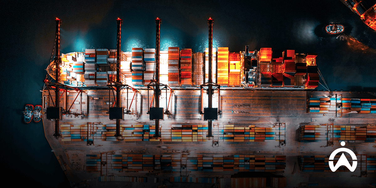 Pemandangan udara kapal kontainer di malam hari sebagai bagian dari sistem manajemen armada kapal pelayaran logistik.